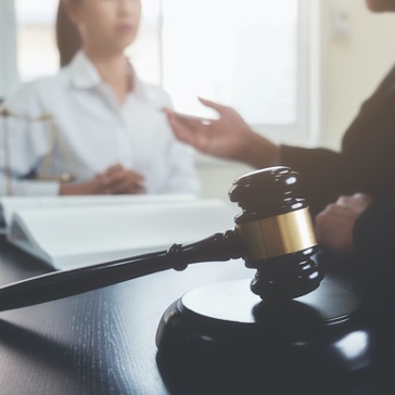 attorneys discussing at a table and a gavel